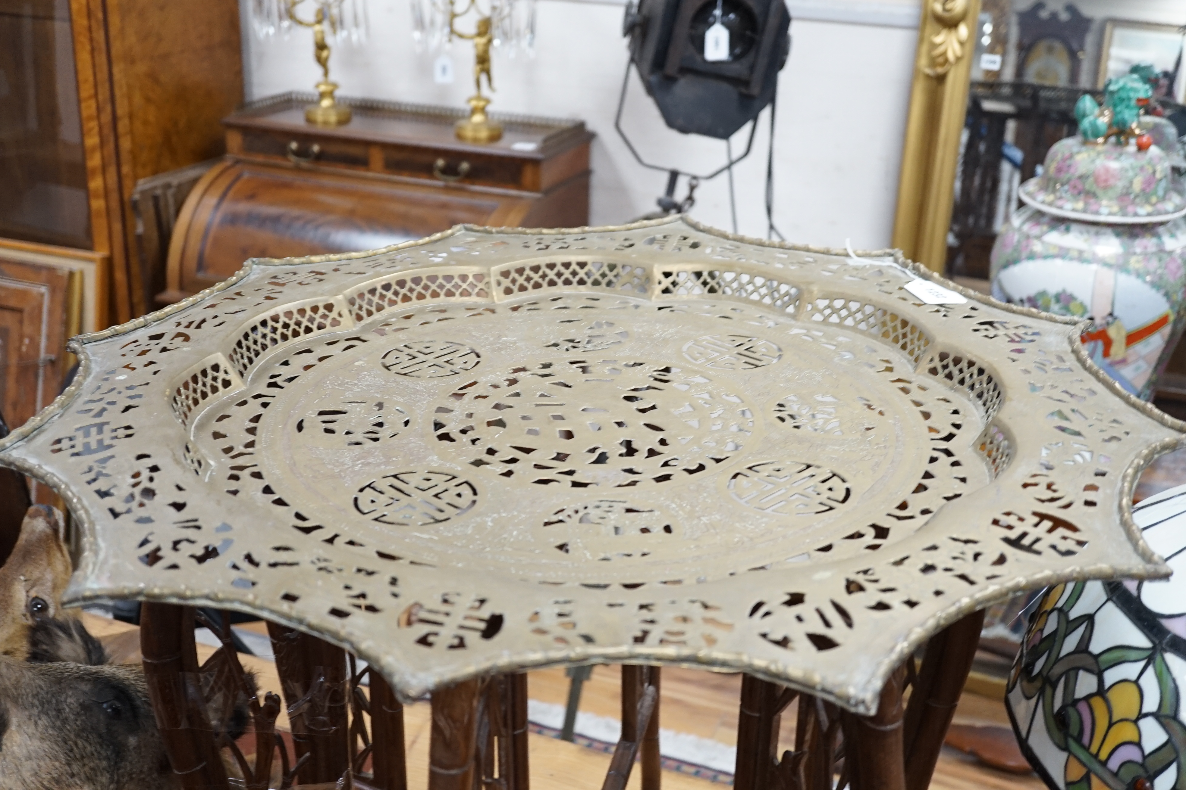 A Chinese circular fretted brass topped folding occasional table, diameter 82cm, height 62cm